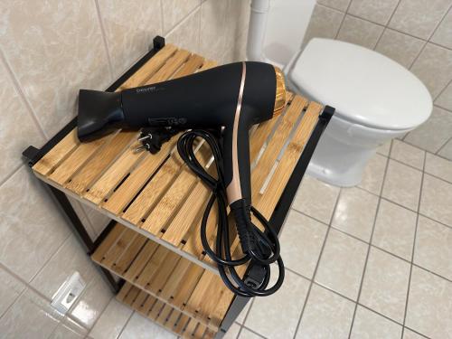 a hair dryer on a wooden table next to a toilet at Panoramablick Scheifling in Lind bei Scheifling