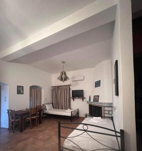 a living room with a couch and a table at Torre di Maina in Kharoúdha