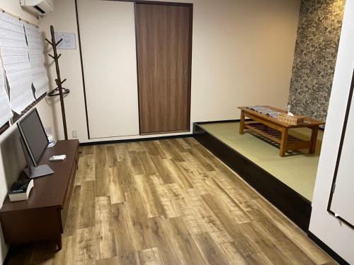 an office with a desk and a door and a table at ABC accommodation in Osaka