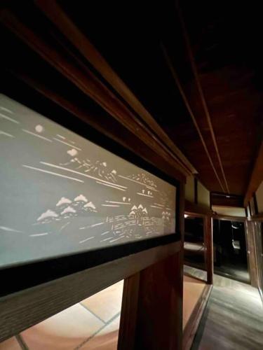a projection screen on the side of a train at Kuon 一棟貸し(素泊まり)北欧サウナ＋ガーデン付き古民家 in Kisa