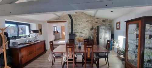 une cuisine et une salle à manger avec une table et des chaises dans l'établissement Longère typique à 2 km de la mer, à Pornic