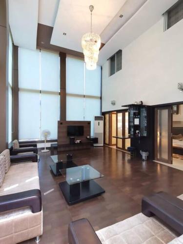 a large living room with a couch and a table at OM SHAKTI in Belgaum