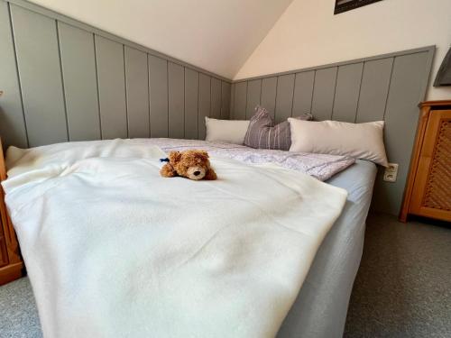 a brown dog laying on top of a bed at Ferienwohnung Martens Villa in Bad Aussee