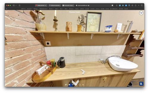 a bathroom with a sink and shelves on a wall at Hostel Pirosmani in Tbilisi City