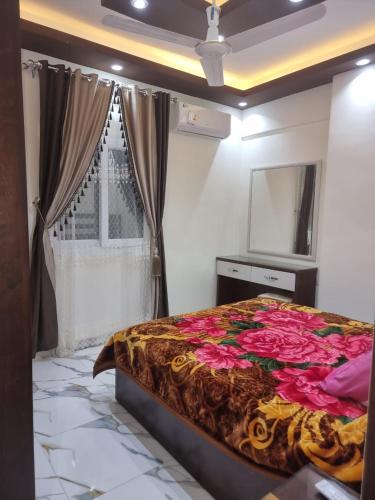 a bedroom with a bed with a mirror and a window at Coral House in Hurghada