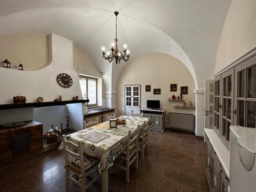 a large dining room with a table and a chandelier at Da Concy in Fossacesia