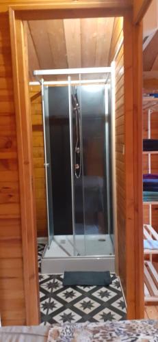 a shower in a room with a glass door at Chambre La Caunette in La Caunette