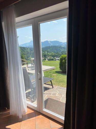 a sliding glass door with a view of a patio at Haus Colorado am Gaisberg in Scheffau am Wilden Kaiser