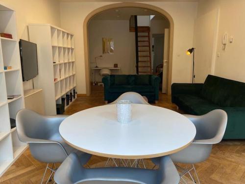 a living room with a white table and chairs at Art Deco - Two bedroom apartment in Ghent