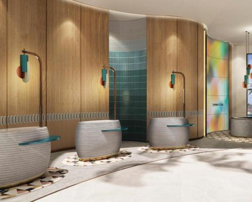 baño con una fila de aseos con azulejos verdes en M Social Hotel Phuket, en Patong Beach