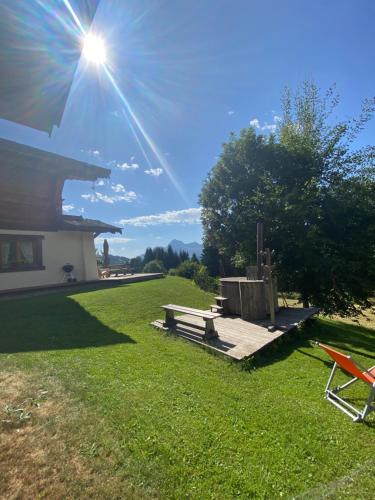 a picnic table and a bench in the grass at La Ferme des Georgières "Séjour en tout compris" in Notre-Dame-de-Bellecombe