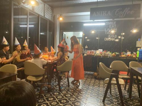 a group of people wearing party hats in a restaurant at Anika Hotel in Ha Long
