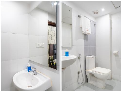a white bathroom with a sink and a toilet at Hotel Marigold Atnest Gachibowli - A Business Hotel in Gachibowli