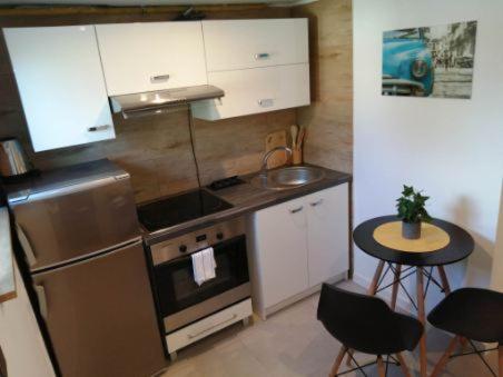 a kitchen with a stainless steel stove and a sink at Apartament Syrenka przy jeziorze Czos in Mrągowo