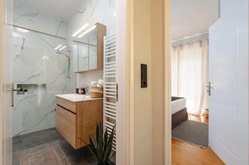 a bathroom with a shower and a sink and a toilet at Stylish 1BD Apt in Elliniko in Athens