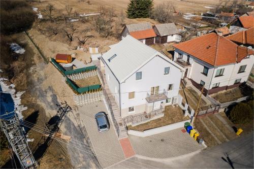an overhead view of a large white house at Totina Apartments in Závažná Poruba