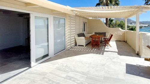 a patio with a table and chairs on a house at Ricardo by the sea in Parikia