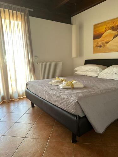 a bedroom with a bed with two towels on it at Le terrazze di Rosa in Polignano a Mare