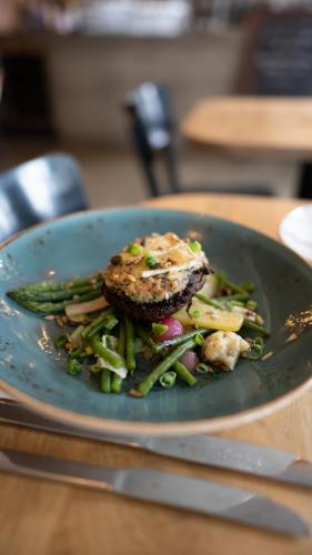 a plate of food with a piece of meat and vegetables at Logement Overzee in Nes