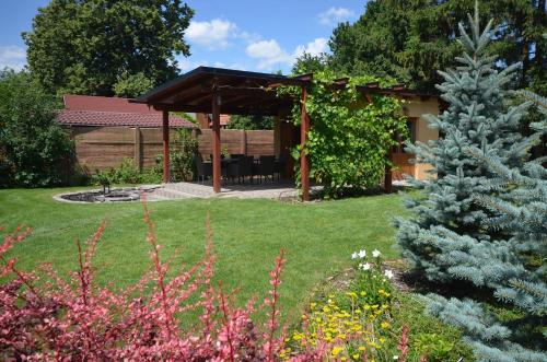 a garden with a gazebo in the background at Apartmány Best I. Bešeňová in Bešeňová