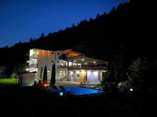 a house with a swimming pool at night at Villa Green Heaven in Sarajevo
