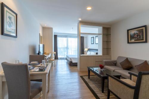 a living room with a couch and a table at Kantary Bay Hotel And Serviced Apartments Sriracha in Si Racha