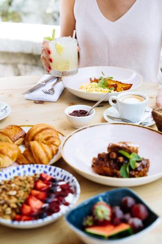 a woman sitting at a table with plates of food at Auberge du Lyonnais in Annecy