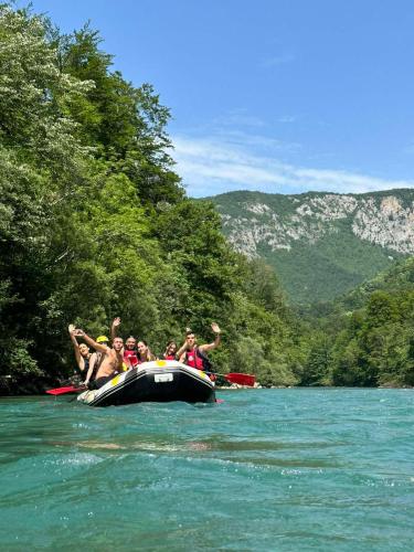 a group of people on a raft in a river at Vucja Gora in Foča