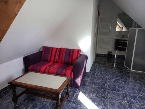 a living room with a couch and a coffee table at Les Lys in Cricquebœuf