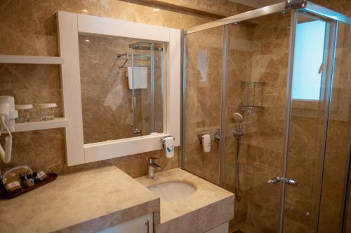 a bathroom with a sink and a shower at Alesta Residence in Fethiye