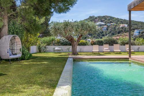 a swimming pool in the yard of a house at Villa Verde Costa Brava - BY EMERALD STAY in Begur