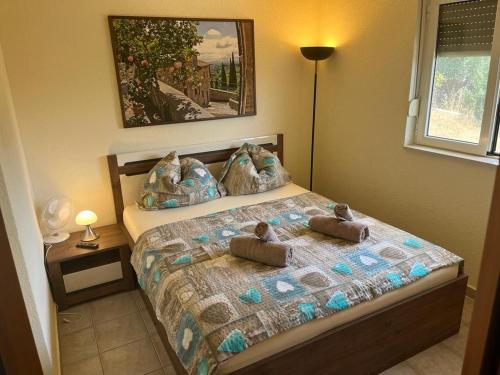 a bedroom with a bed with two towels on it at Villa West Point in Okrug Donji