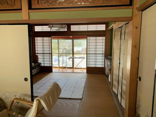 an entrance to a room with a door open at 余呉の里山-ランプの宿-さくら in Nagahama