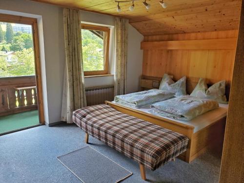 een slaapkamer met een bed en een raam bij Haus an der Sonne FeWo 2 in Biberwier