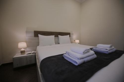 a bedroom with a bed with towels on it at OXYGEN Shekvetili in Shekvetili