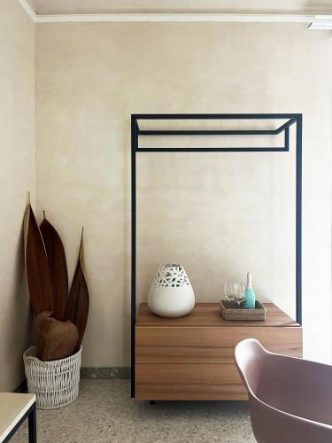 a mirror in a room with a table and a chair at La casa di Irene - Suites con vista in Ragusa
