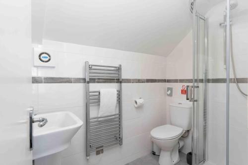 a white bathroom with a toilet and a sink at Room 5, Hotel style Double bedroom in Marazion in Marazion