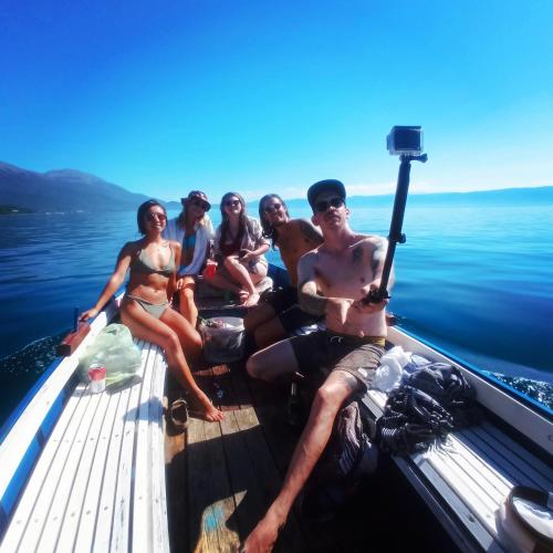 a group of people sitting on a boat on the water at Sunset Lake hostel in Ohrid