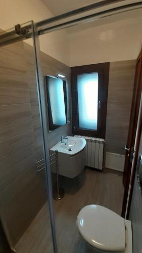 a bathroom with a sink and a toilet and a shower at Villa Saponaro - Affittacamere in Torre Lapillo