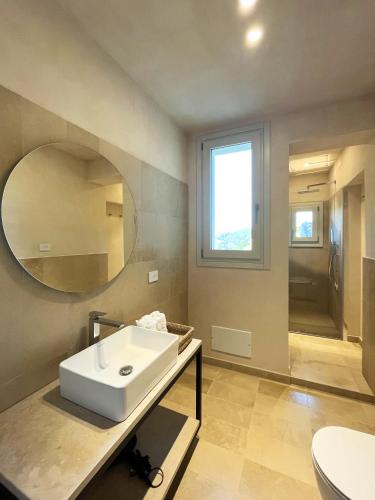 a bathroom with a sink and a mirror at La casa di Irene - Suites con vista in Ragusa