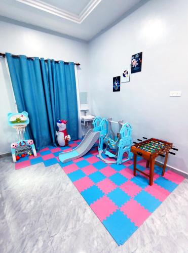 a play room with two chairs and a rug at DLuna Homestay Terengganu in Kuala Terengganu