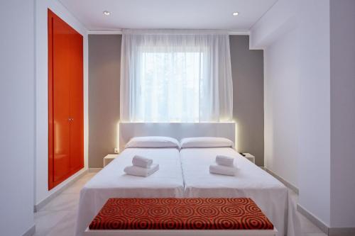a bedroom with a white bed and a window at Hotel DL Port in Castellón de la Plana