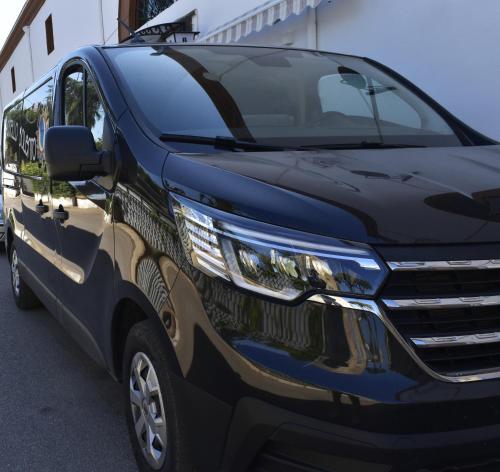 a blue van parked in a parking lot at Ostello Salento in Alezio