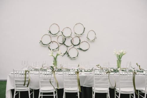 a table set up for a wedding with white chairs and mirrors at Mövenpick Hotel Sukhumvit 15 Bangkok in Bangkok