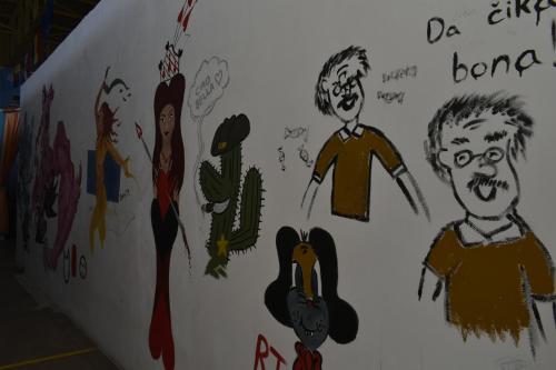 a wall with drawings of people on it at Ostello Salento in Alezio