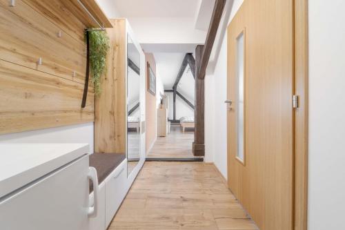 a hallway of a house with wooden walls and wooden floors at GUDU apartments in Košice