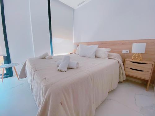 a bedroom with two beds with towels on them at Exclusivo Ático de Lujo en la Playa - holaVivienda Inmobiliaria in Denia