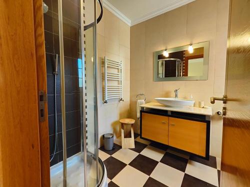 a bathroom with a sink and a shower at Vila Limoeiro in Salir de Porto