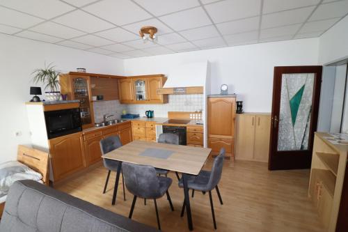 a kitchen with a table and chairs in a room at Ferienwohnung GGM in Judenburg