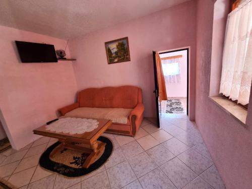 a living room with a couch and a table at Zlata Apartment in Fužine